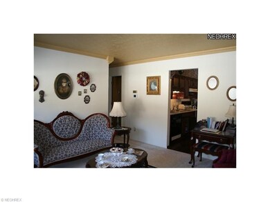 Living room with crown molding and new carpet in 2