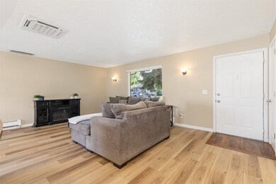 Living area with light wood finished floors and a