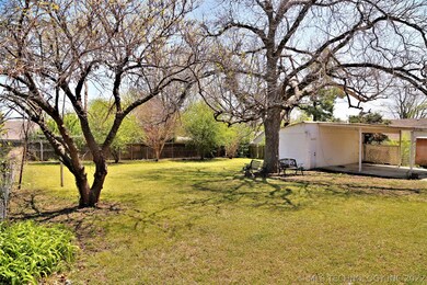 Nice yard with mature trees and another view of st