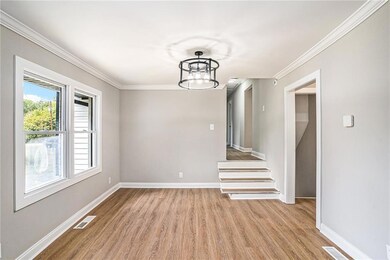 Unfurnished dining area featuring a chandelier, li