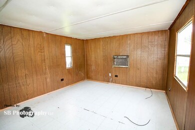 Spare room with wood walls, light tile flooring, a