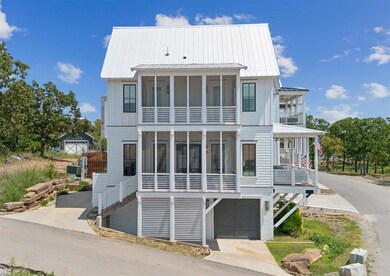 Lake home featuring an attached garage, a sunroom,