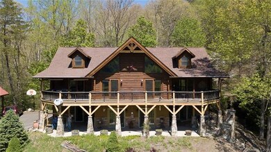 Back of house with huge upper deck and lower patio