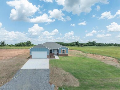 Single story home with a garage and a front lawn
