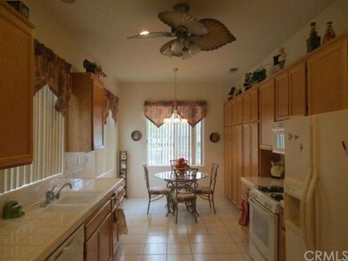 Eat in kitchen with tile flooring, tile counters a