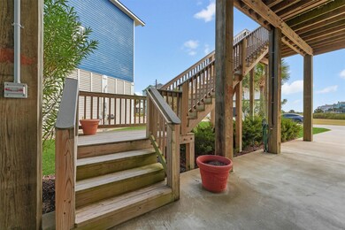 Welcoming steps lead to the front entry, where elegant craftsmanship and coastal charm set the tone for the luxury that awaits inside.