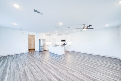 Unfurnished living room with light wood-style floors, recessed lighting, and a ceiling fan