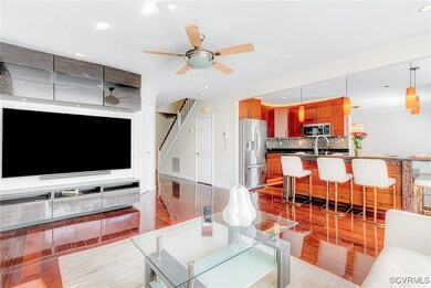 Living room featuring ceiling fan and sink