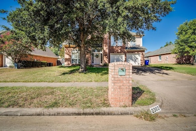 View of front of property with a garage, a front y