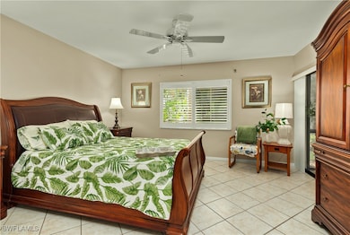 Bedroom with light tile patterned floors, baseboar