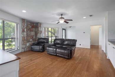 Living area with light wood-type flooring, ceilin