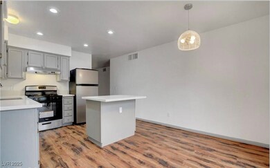 Kitchen with light countertops, under cabinet rang