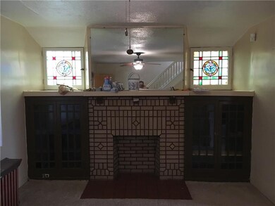 Large Living room with built ins and stained glass