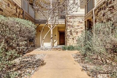 View of exterior entry with stone siding and a ba