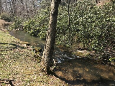 View of small stream running along front of proper