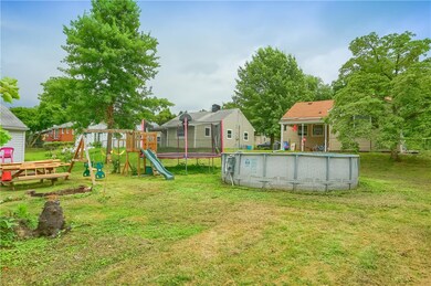 Very flat and usable yard with a pool, playset, an