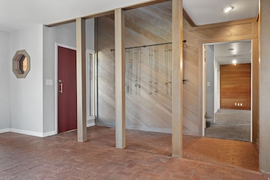 Interior space with brick flooring and wood walls