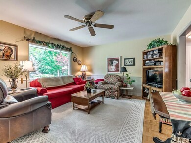 Living room featuring ceiling fan and parquet floo