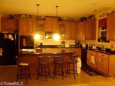 Kitchen. Kitchen has beautiful cabinetry and gleaming granite countertops. Kitchen island is quite large and will serve you well when entertaining for the holidays.