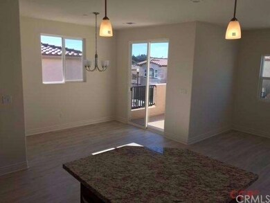 Dining area with sliding door to balcony.