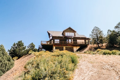Back of house featuring a wooden deck and a metal roof