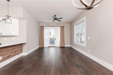 Unfurnished dining area featuring dark wood finished floors and a chandelier