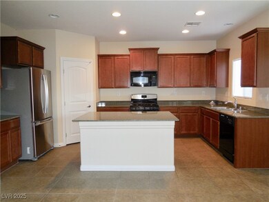 Kitchen with black appliances, a sink, a kitchen i