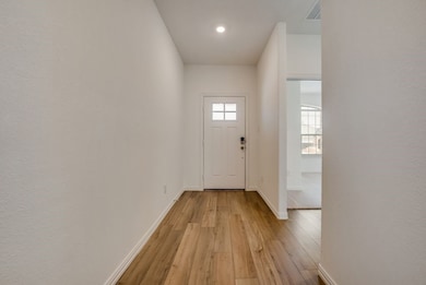 Entryway featuring light wood-type flooring and recessed lighting