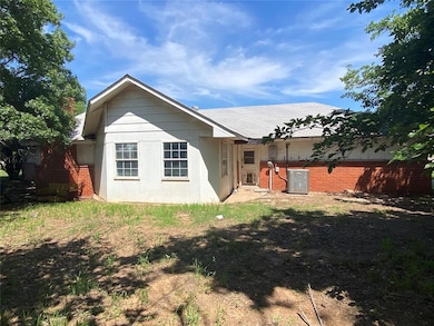 Rear view of property with central AC unit
