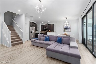 Living room with a chandelier and light wood-type