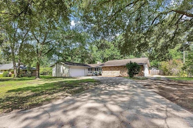View of front of house featuring asphalt driveway, an attached garage, a front yard, and a chimney