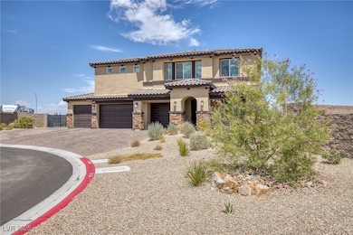 Mediterranean / spanish home featuring stucco siding, stone siding, a tiled roof, decorative driveway, and an attached garage