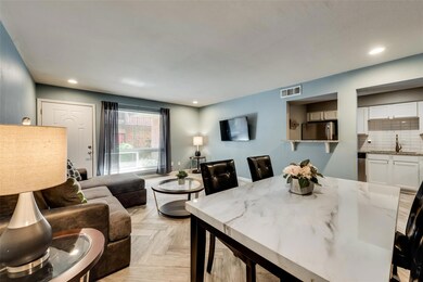 Dining area featuring sink and light parquet floor