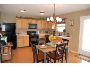 Kitchen. Large 16x12 eat-in kitchen boasts laminate flooring, upgraded oak kitchen cabinets with attractive pulls, upgraded light and plumbing fixtures and upgraded appliances-all of which stay!  There is a huge walk-in pantry as well.