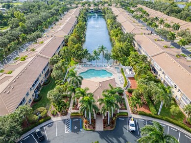 Bird's eye view of a pool area and a nearby body of water