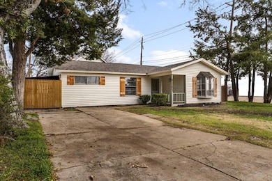 Single story home with covered porch and a front y