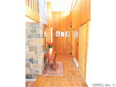 Foyer. Large front foyer with stone chimney.