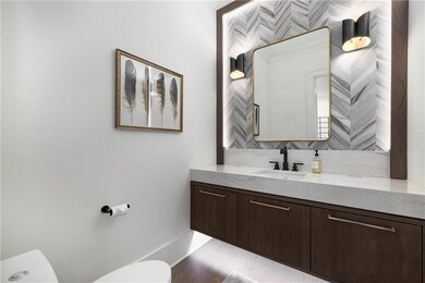Bathroom featuring vanity and backsplash
