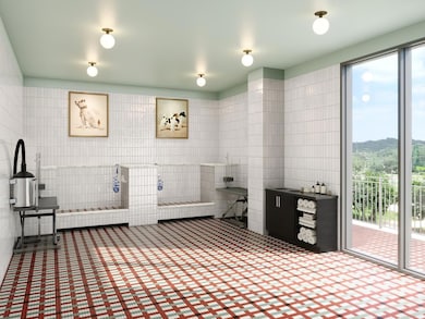 Pet spa with indoor wash and grooming stations, towel storage, and direct access to the outdoor pet area. Designed as a comfortable, social space where residents can enjoy time with their pets and friends.