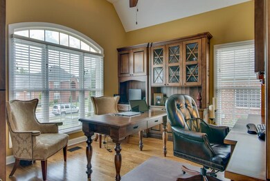 Comfortable, spacious study with walnut cabinetry and shelving that remain with home