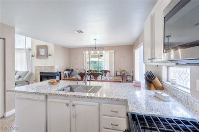 Kitchen featuring stainless steel microwave, white