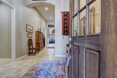 This home opens up to a formal entry and dramatic hallway to dining and living room.  The front door has been refinished since photo was taken.