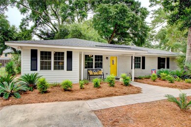 Paved driveway and plenty of parking surround this