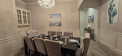 Formal dining room with wood finished floors, orna