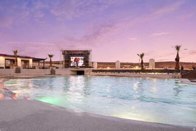 Pool at dusk with a community pool and a patio