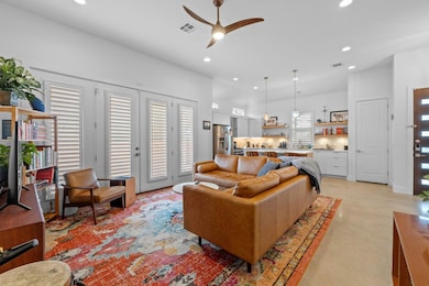 Living room with a ceiling fan and recessed light