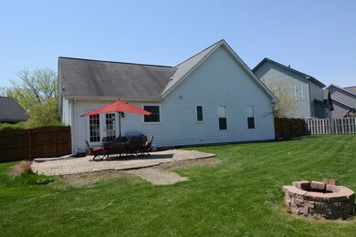 Huge backyard with patio and fire pit.