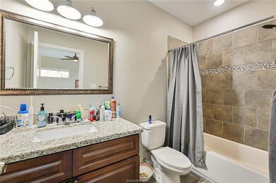 Full bathroom featuring toilet, vanity, shower / b