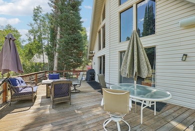 Wooden terrace with outdoor dining space and area for grilling