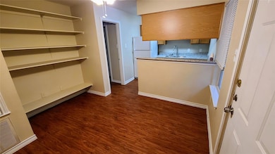 Kitchen featuring brown cabinets, a sink, freesta